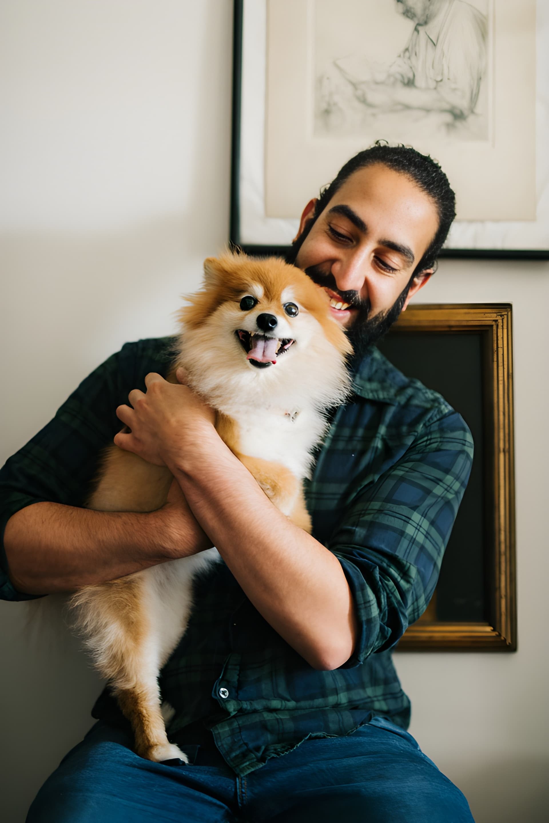 A happy Koala customer holding their pet dog after seeing how easy pet medication can be